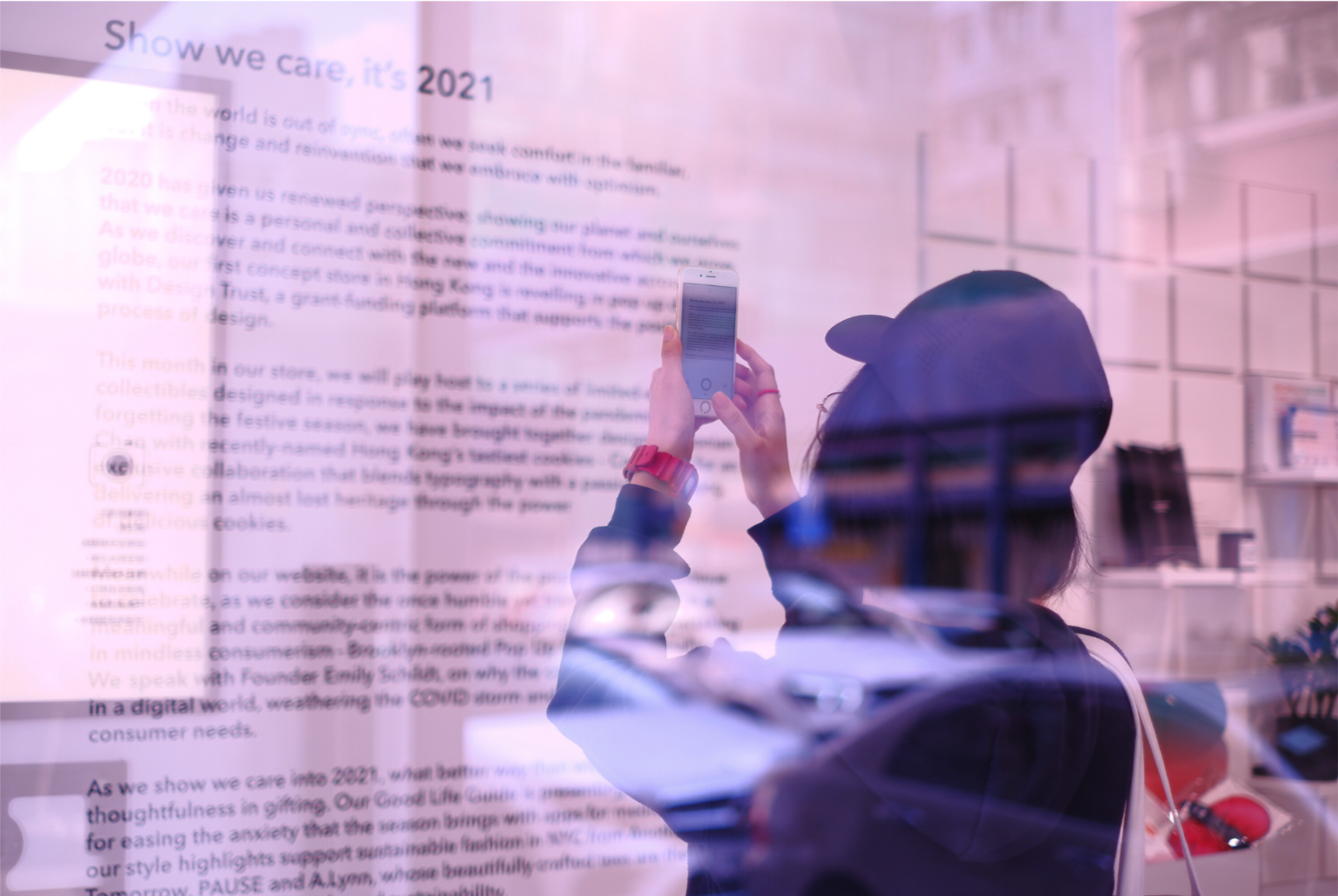Visitor photographing the WSNXT window display and editorial installation