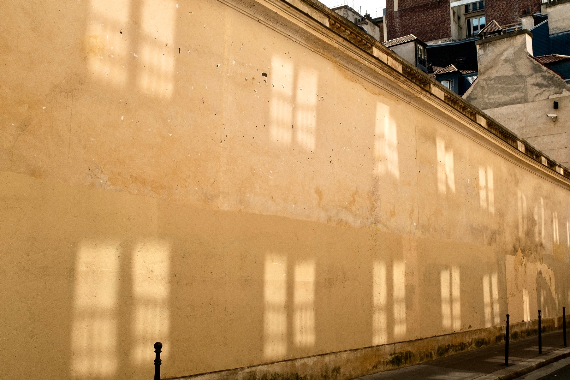 Reflected window light on a Paris wall