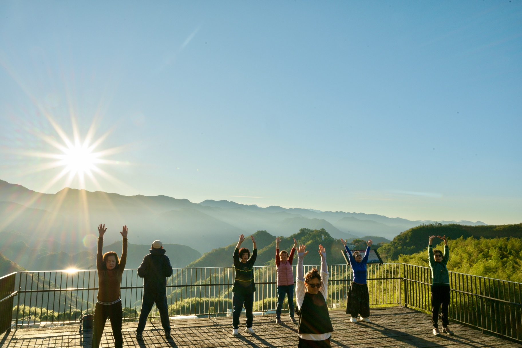 Morning exercise on a mountain platform at sunrise